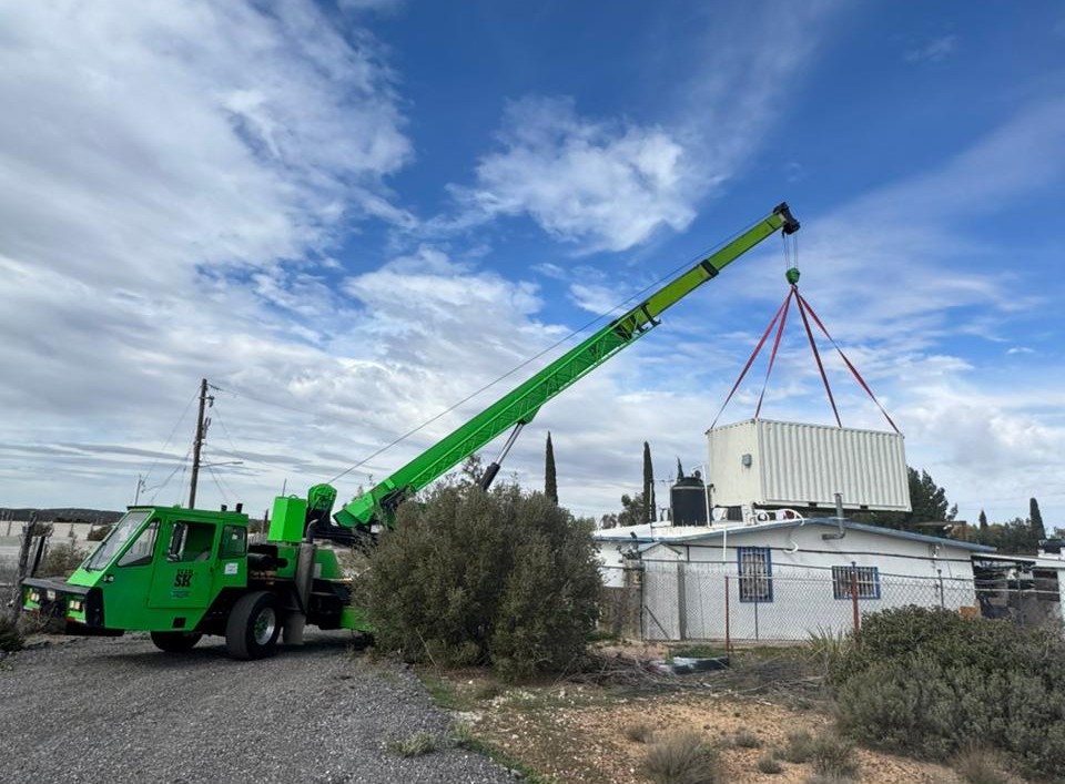 Grúa industrial realizando izaje de contenedor sobre estructura en Tijuana